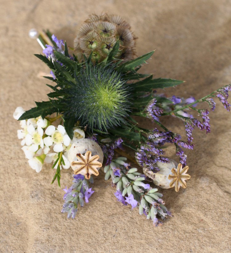 rustic grooms buttonhole with eryngium thistle, lavender, scabious, poppy seed heads and limonium