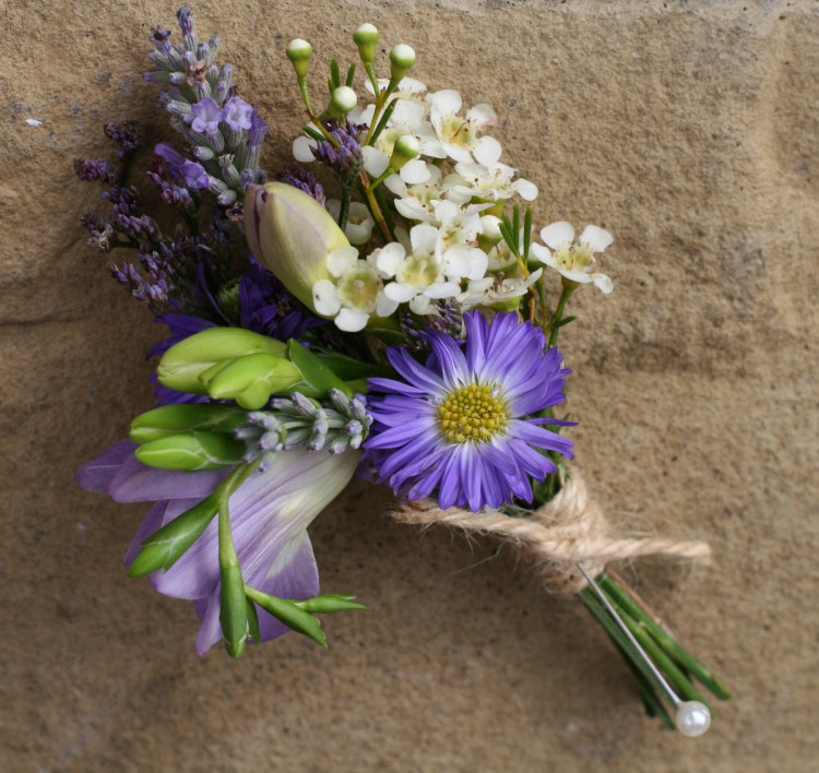 rustic ladies corsage pof freesia, waxflower, lavender, september and limonium