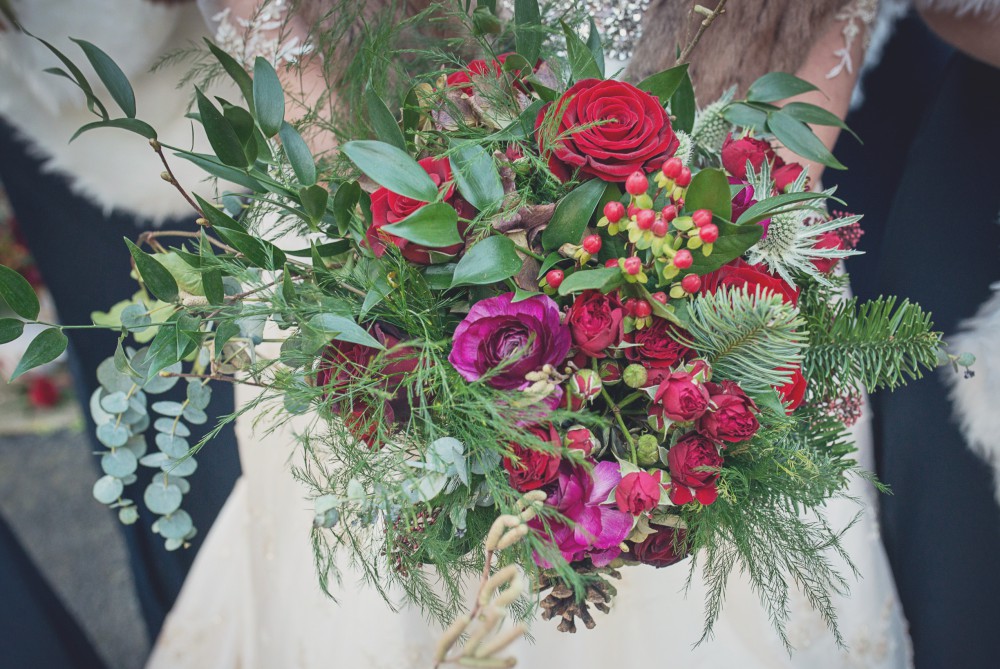 red and green winter wedding brides bouquet
