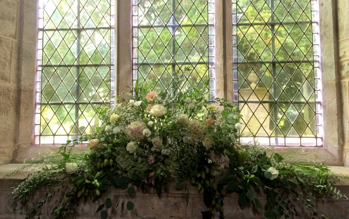 windowsill arrangement wedding flowers at St Bartholomews church Homme House