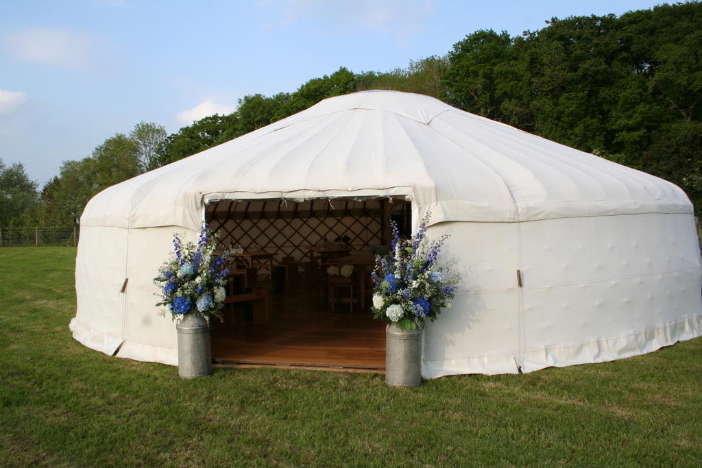 blue and white churn arrangement for a yurt wedding
